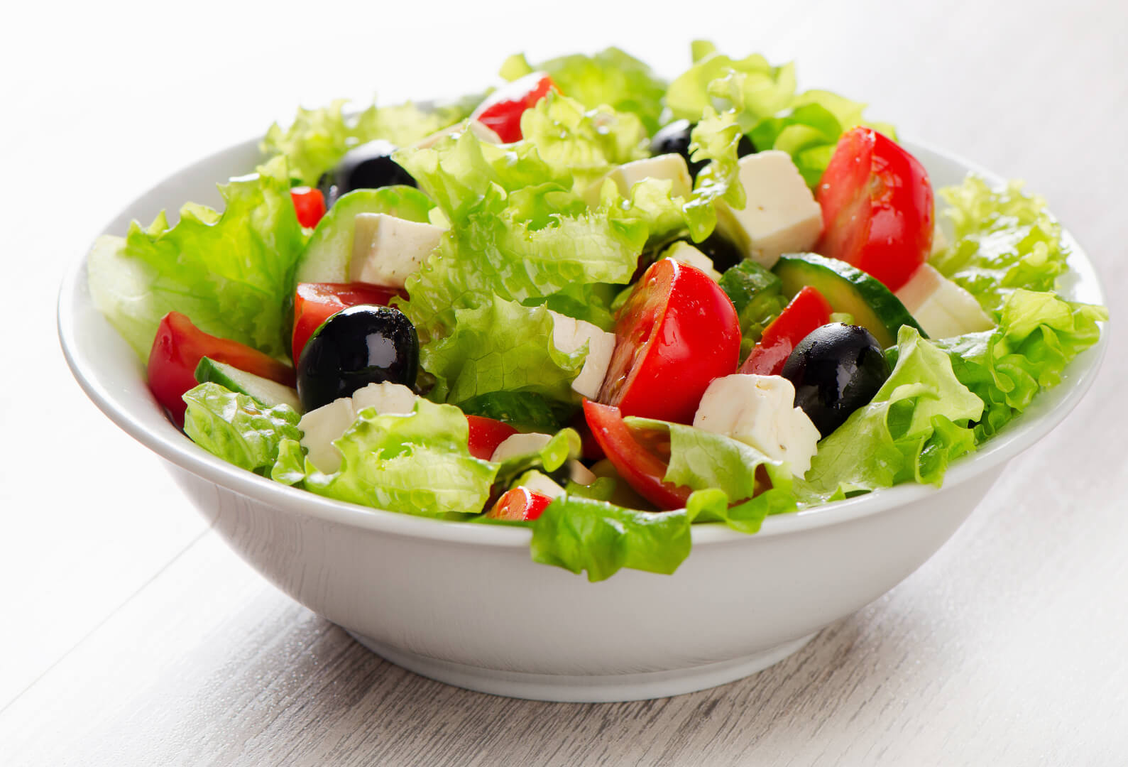 Fresh vegetables salad with feta, olives and tomato.